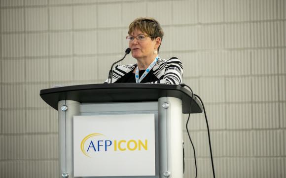 a person speaking from a podium at AFP ICON